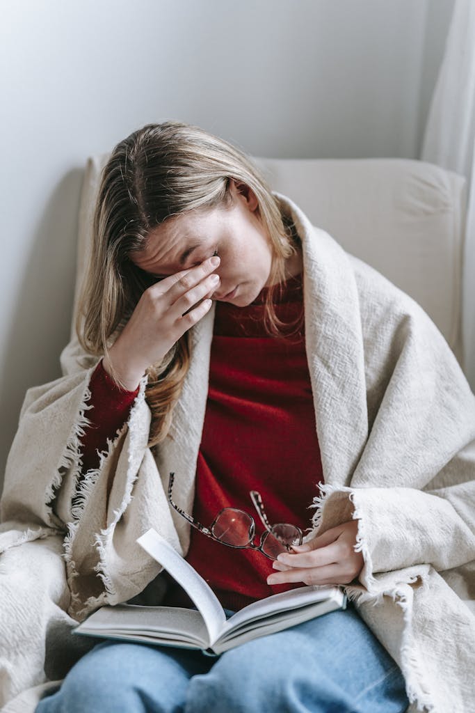 A Woman Rubbing her Eyes with her Hand