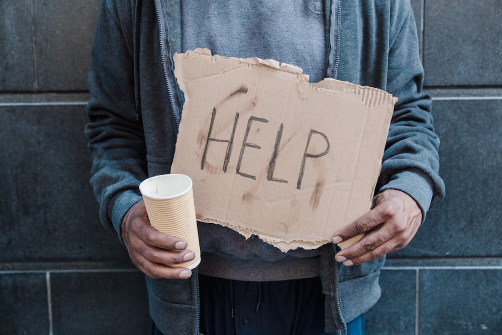 Man Holding Placard Saying Help