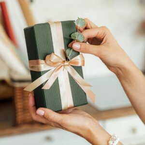 Person Holding a Gift with Ribbon