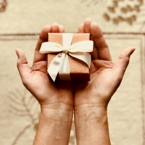 Person's Holds Brown Gift Box